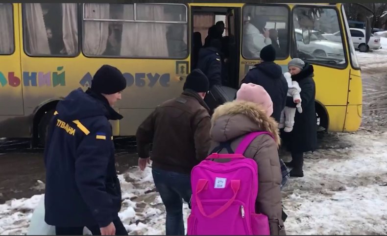 Ukrainians board a bus in Sumy