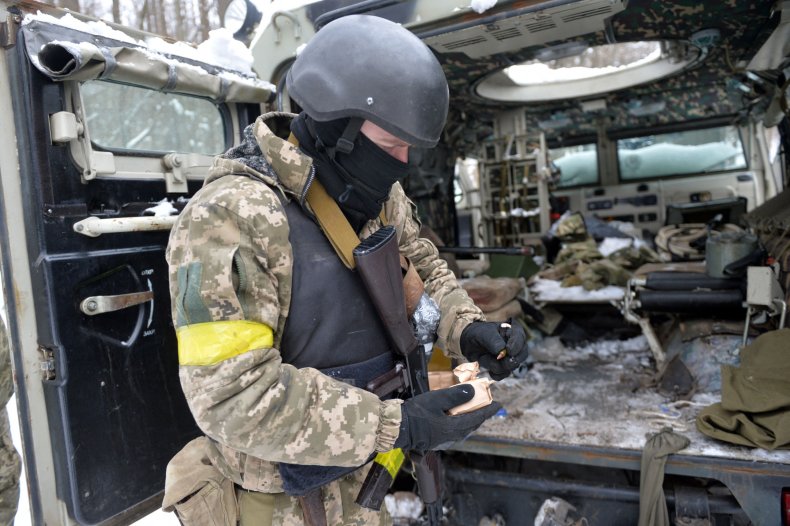 Ukraine soldier with Russian vehicle outside Kharkiv