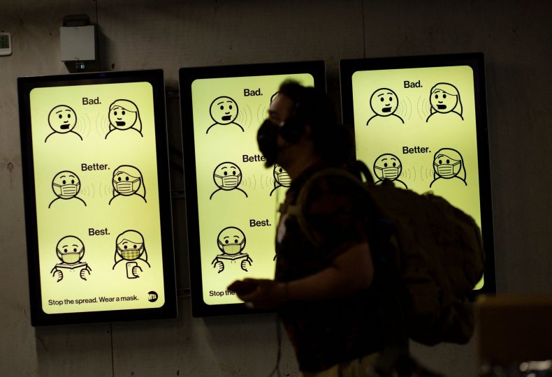 A sign displays mask wearing information
