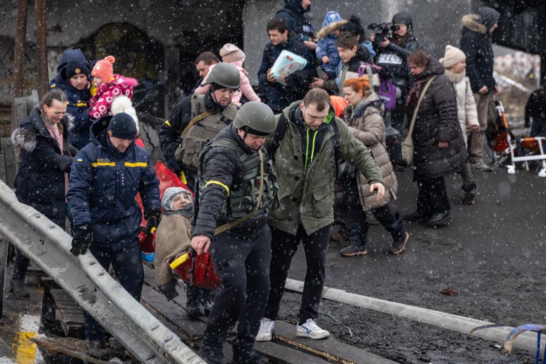 Ukrainians cross an improvised path
