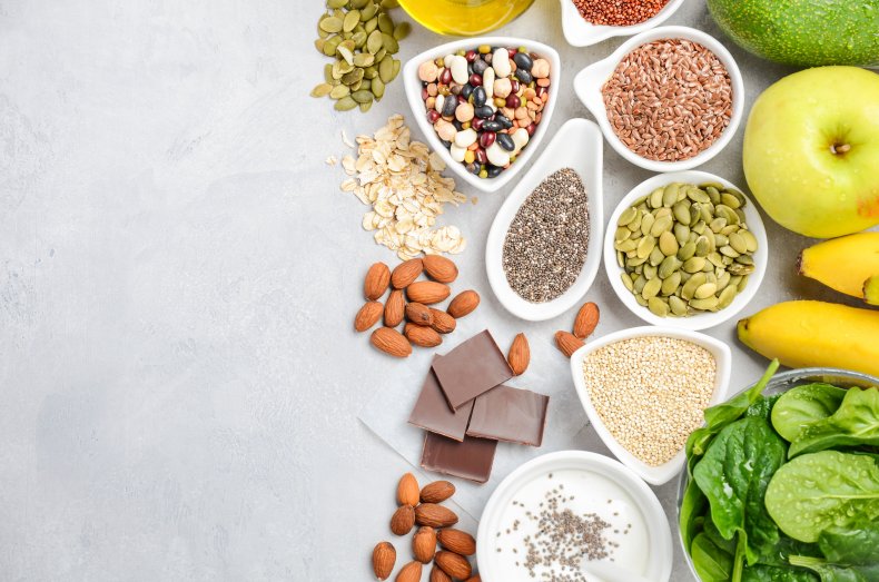 A table spread of nuts, seeds, vegetables.