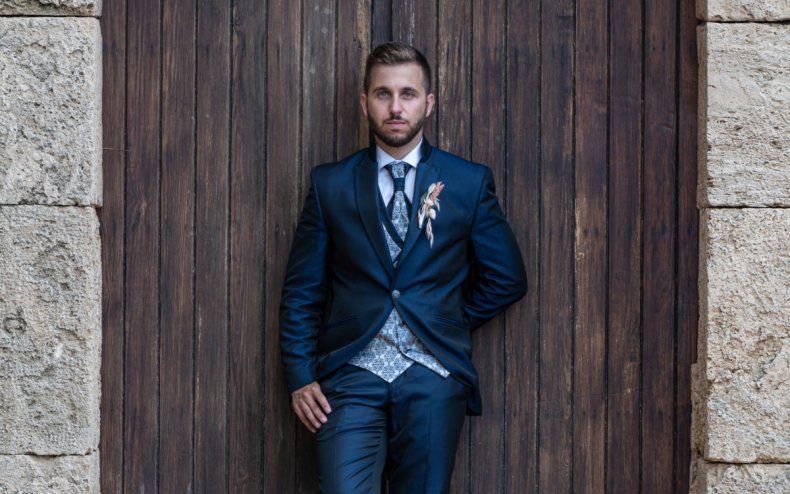 A groom outside a church door.