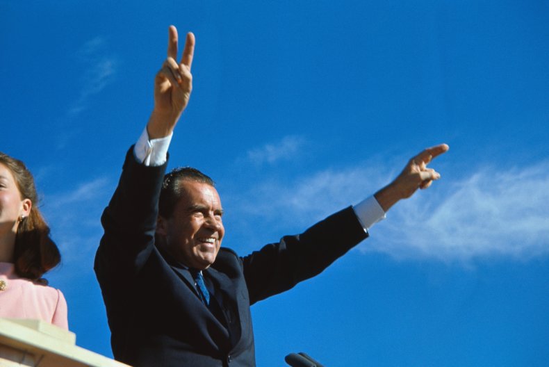 Richard Nixon gives his well-known two-armed victory 