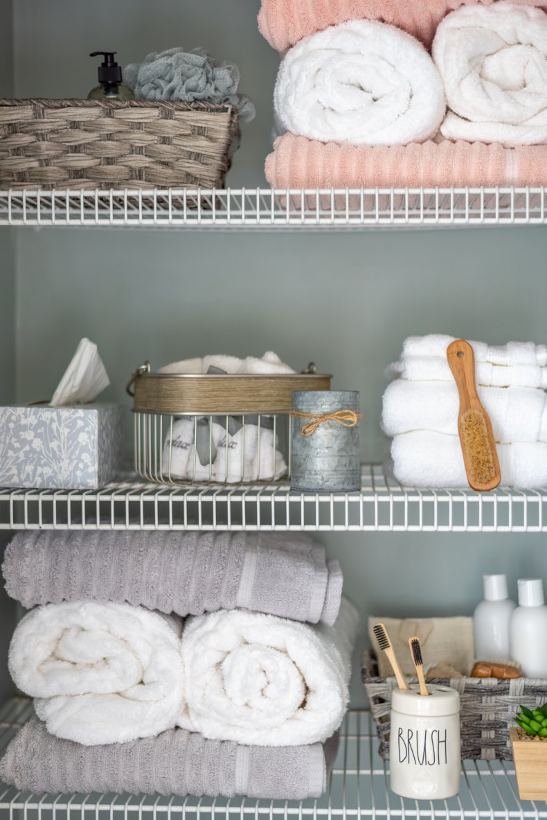 Neatly organized bathroom linen closet 