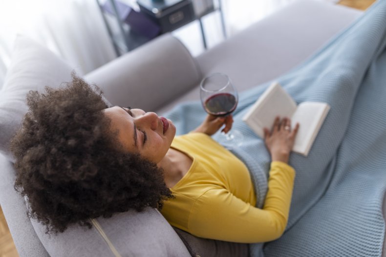 A woman relaxing with glass of wine.