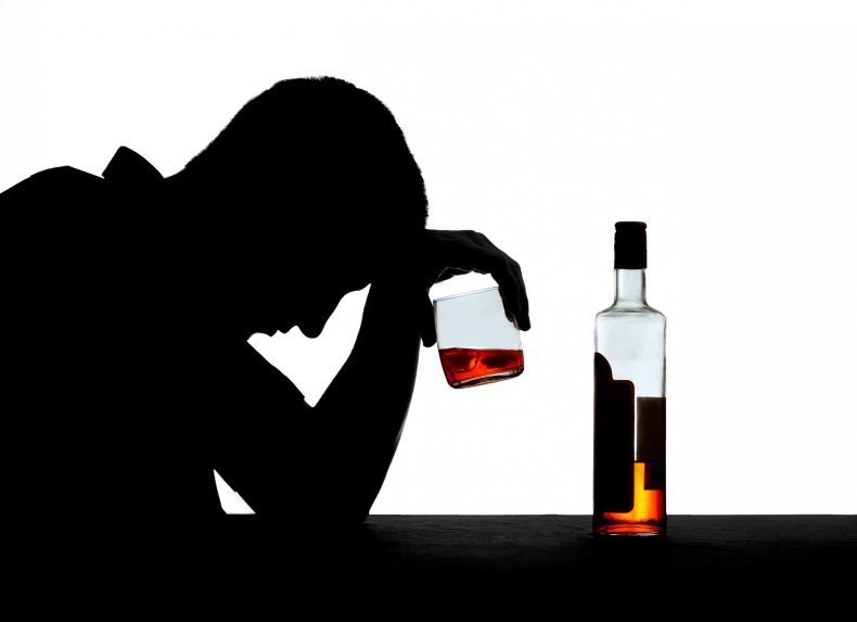 A silhouette of a man drinking alcohol.