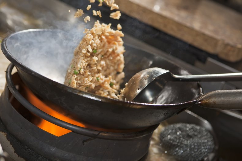 fried rice being cooked in wok