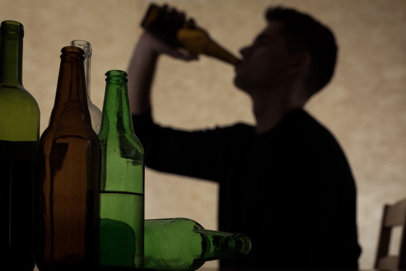 A silhouette of a person drinking. 