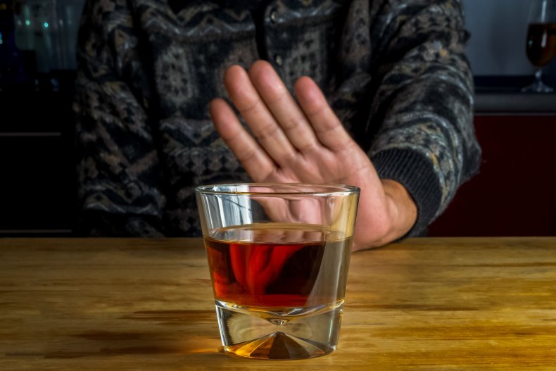 A person refusing an alcoholic drink.