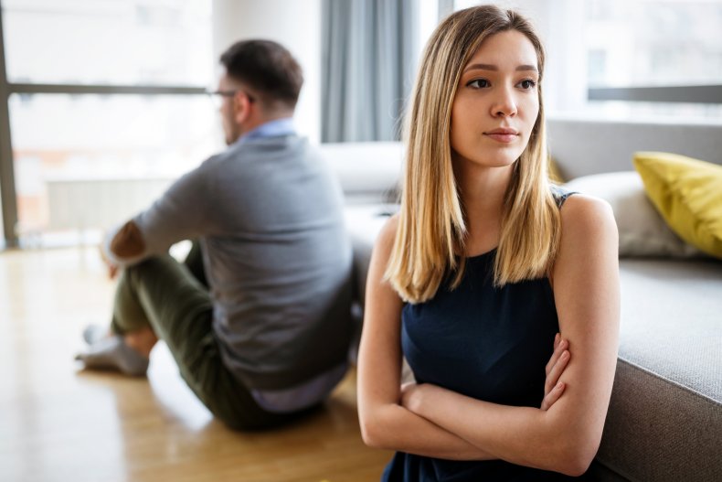 A couple sitting on the floor.