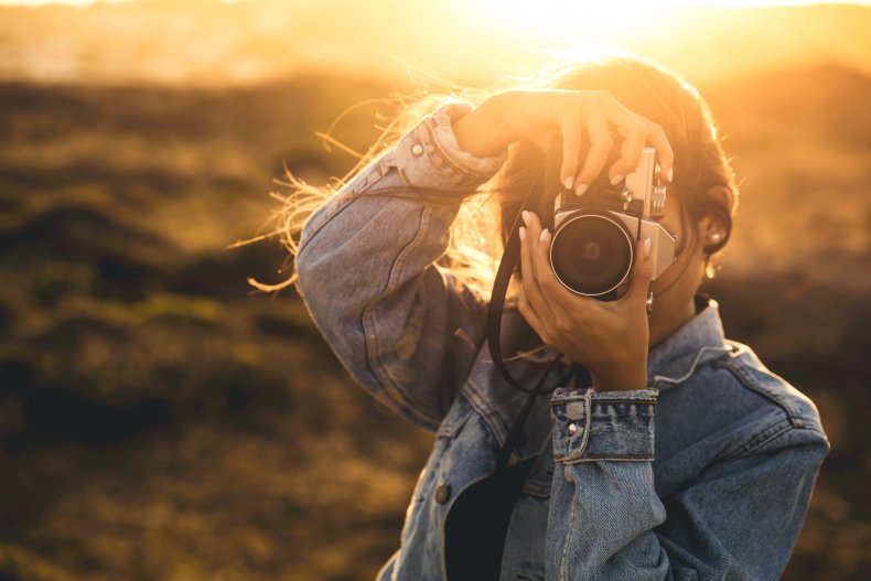 A woman taking pictures outdoors.