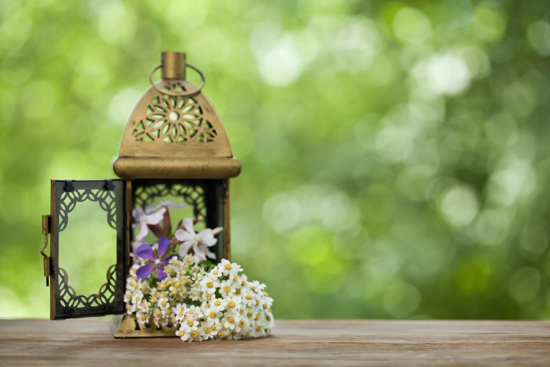 Flowers spilling out of a lantern holder.