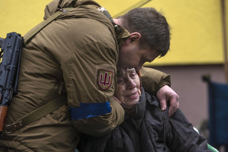 Solider comforts woman