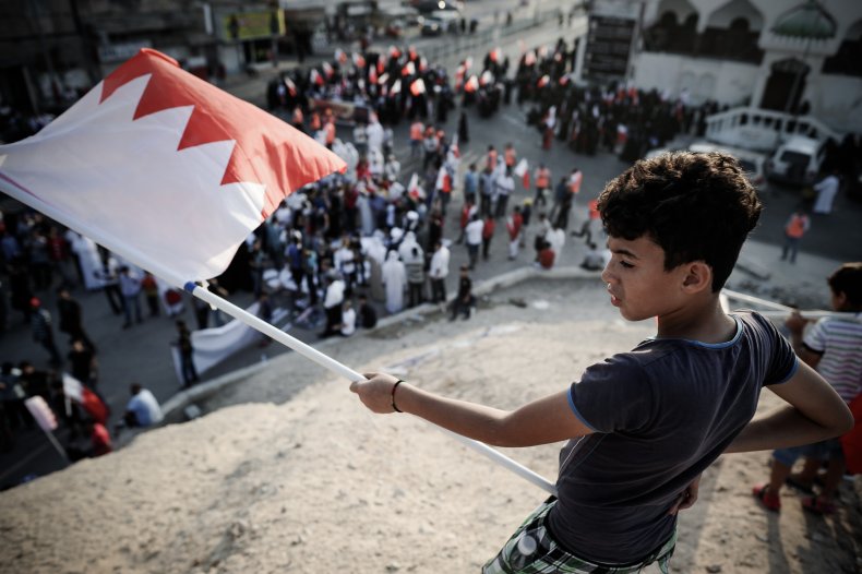 A Bahraini boy holds the national flag 