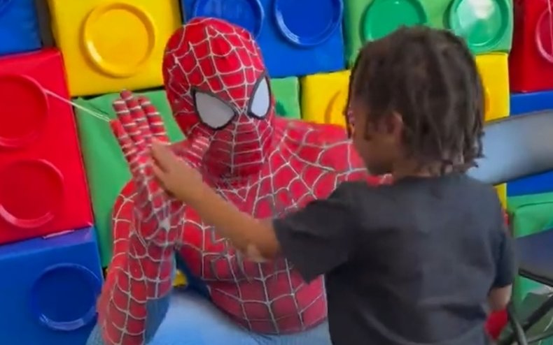 A dad surprising his son as Spider-Man.
