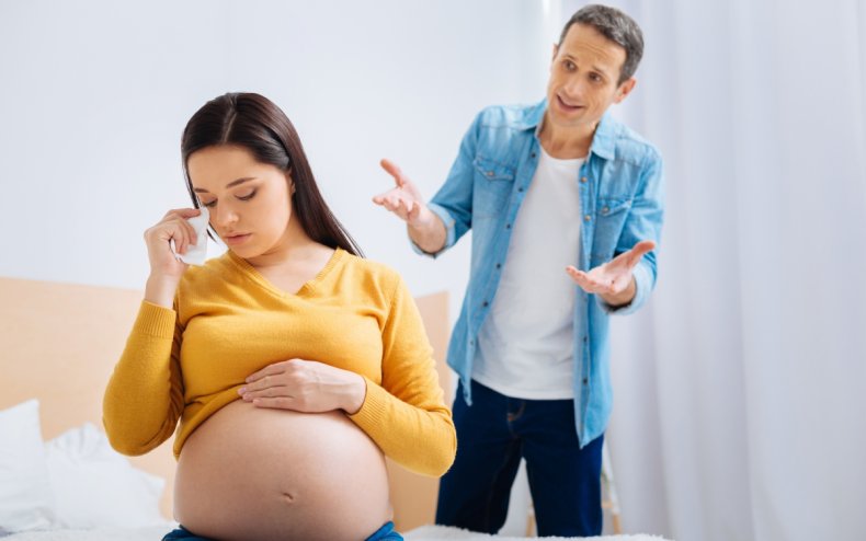 A man and a heavily pregnant woman.