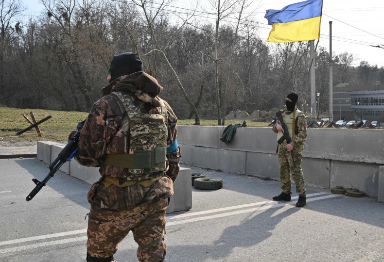 Ukraine soldiers near flag