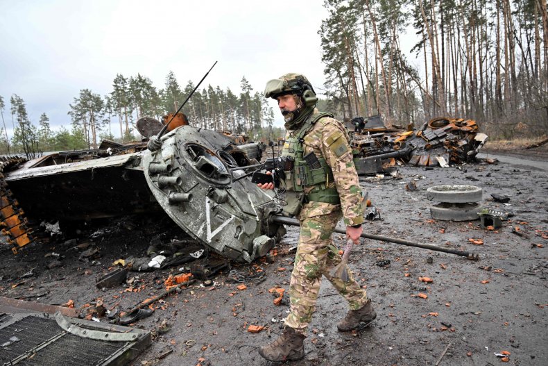 Ukraine soldier with destroyed Russian tank Kyiv