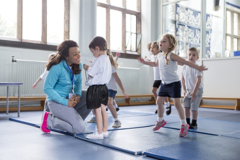 Teacher with kids in school gym class.