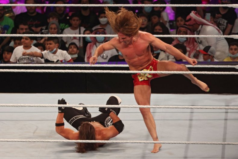 Riddle (R) competes with AJ Styles in