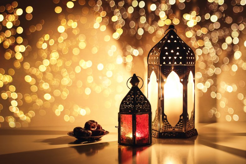 Ornamental Arabic lanterns with burning candles. Glittering 