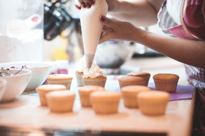 Putting icing on cupcakes