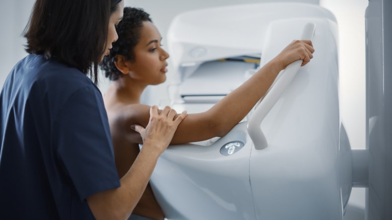 A woman undergoing a mammogram scan.