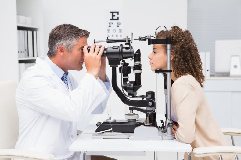 An optometrist administering an eye exam. 