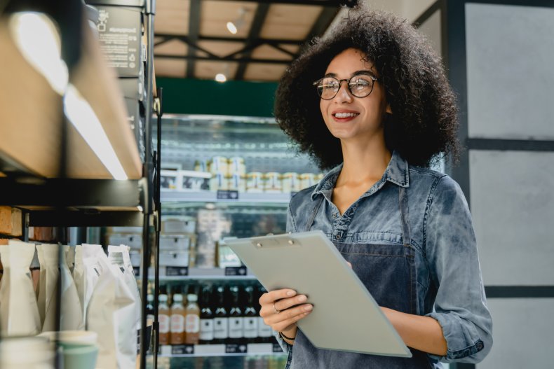 A woman with clipboard checking coffee inventory.