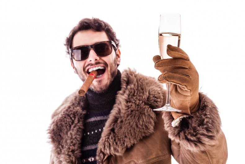 A man with sunglasses, cigar and champagne.