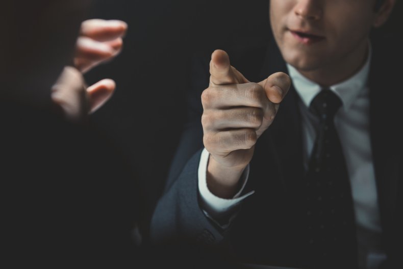 A man pointing his finger at someone.