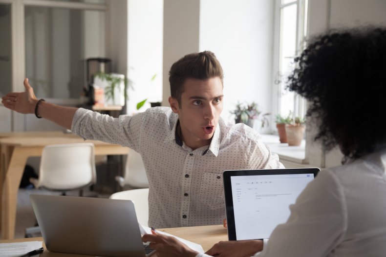 A man arguing with woman at office.