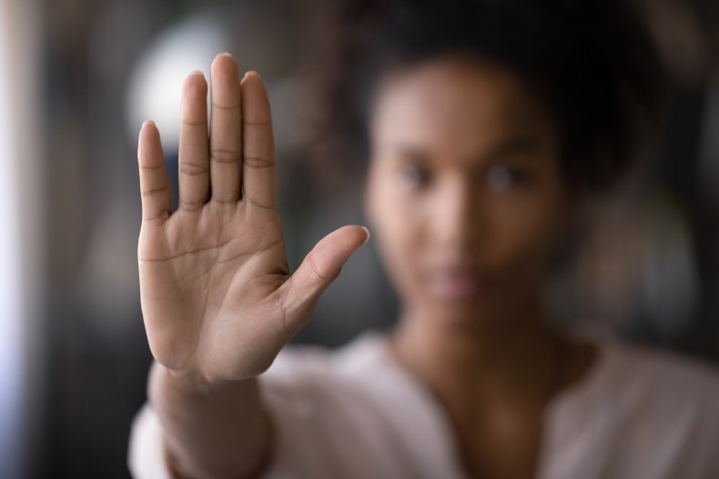 Women raising hand to say stop