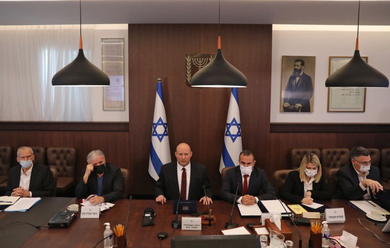 Israeli Prime Minister Naftali Bennett (C) attends