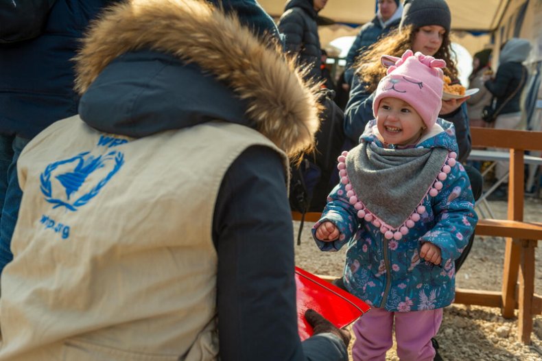 Child from Ukraine greets a WFP worker