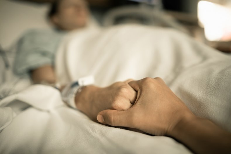 Hospital bed holding hands