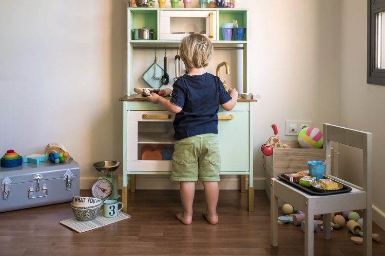 Little boy playing with kitchen set