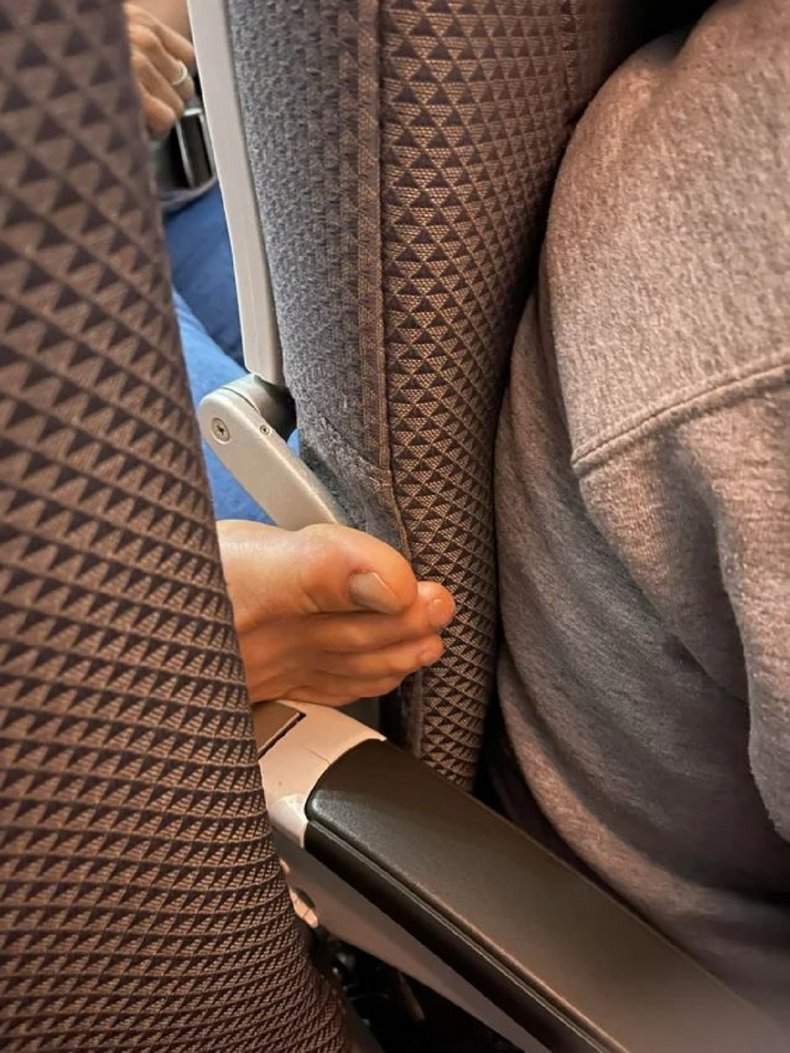 Photo of foot on plane seat.