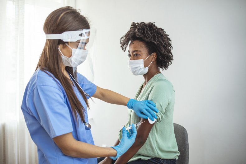 A nurse administering vaccination to a patient. 