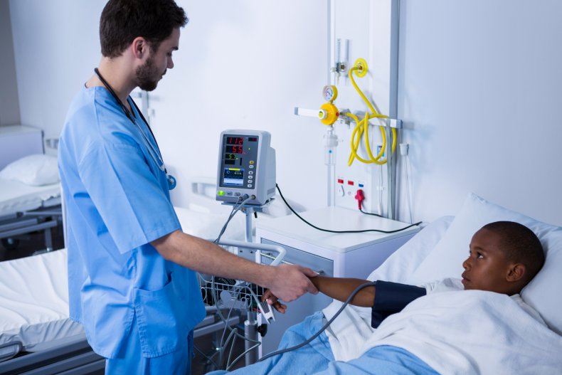 A male nurse measuring patient's blood pressure.