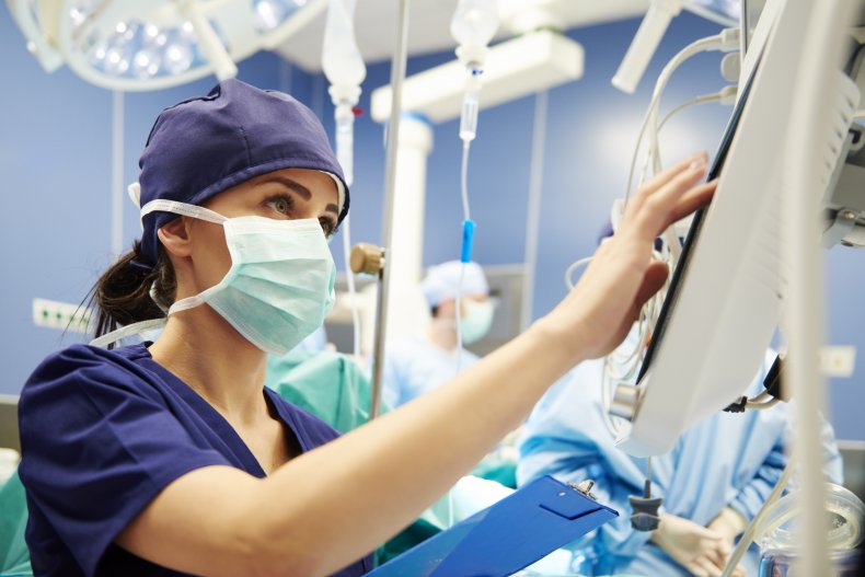 A nurse operating device in hospital room.