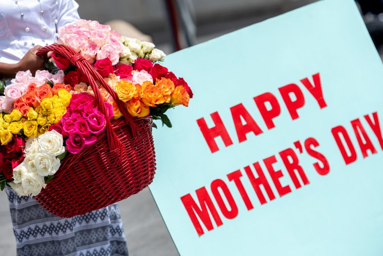 Woman holds a large basket of flowers