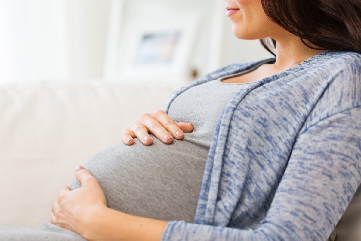Pregnant woman sitting on couch