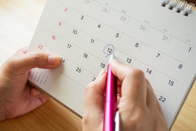 A person looking at different calendar dates.