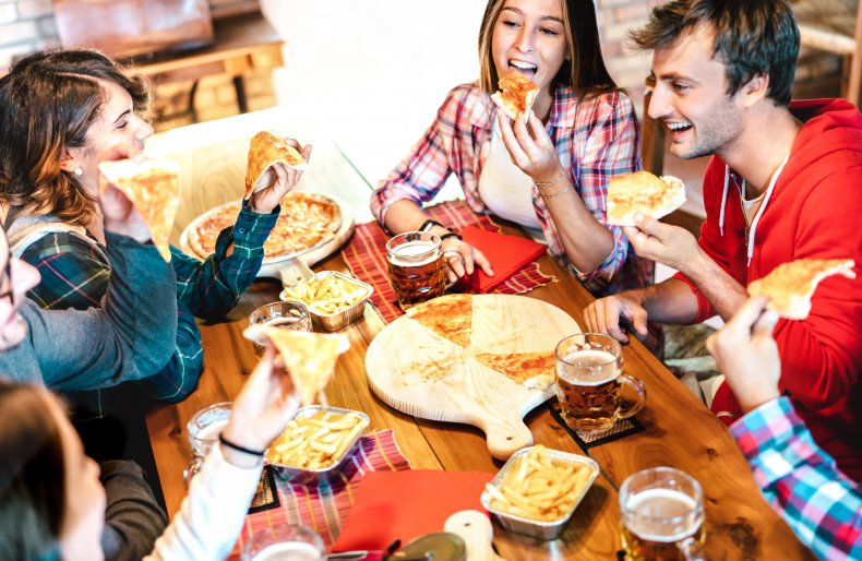 Teens eating pizza