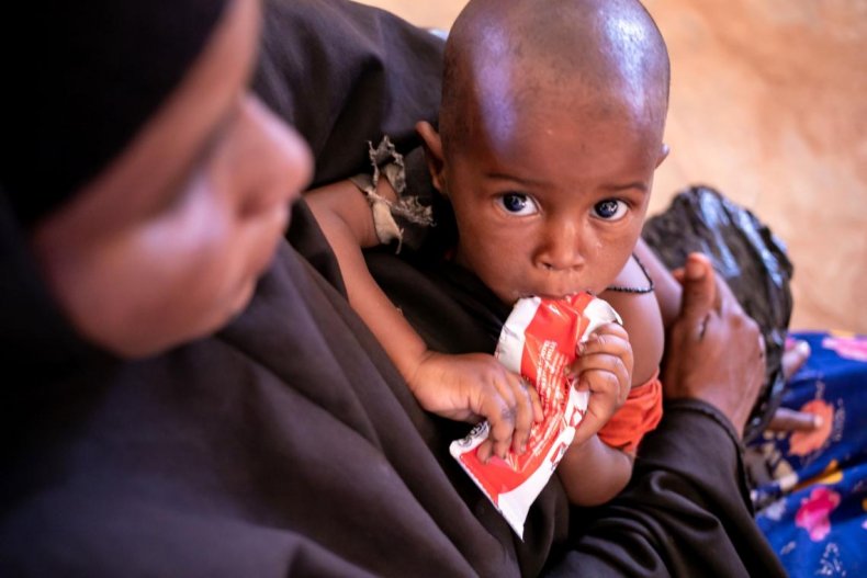 A child held by his mother