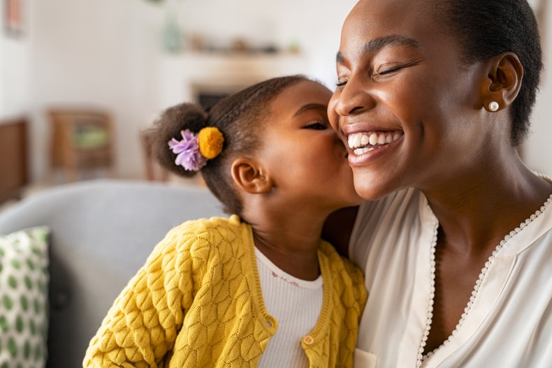 A child kisses their mother.