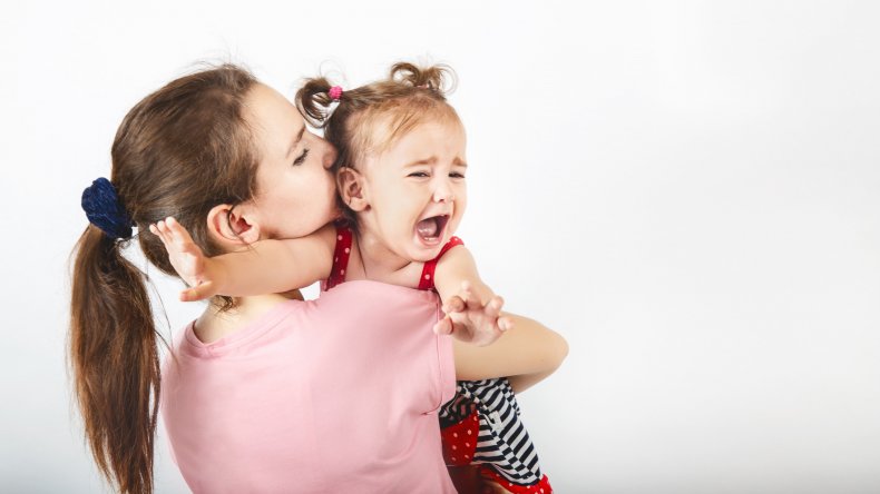 Mother hugging crying toddler