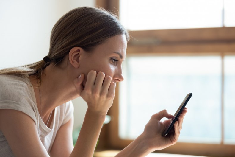 Woman reading text from disgruntled neighbor