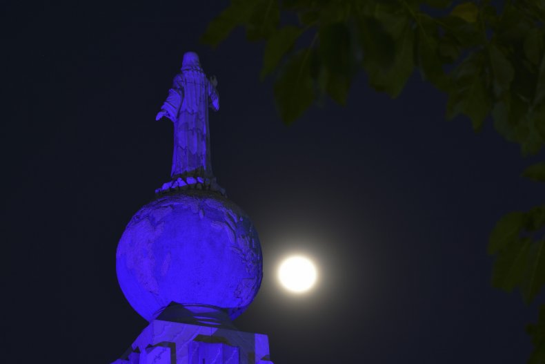 The full moon rises over San Salvador